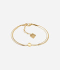 Bracelet Pepita Zag, double chaîne fine et boule de métal en acier doré à l'or fin